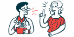 A person in a red shirt talks with a clinician in a white coat and glasses.