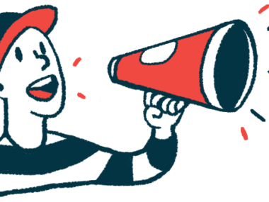A person in a baseball cap speaks using a megaphone.