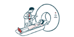 A person prepares to enter a scanner.